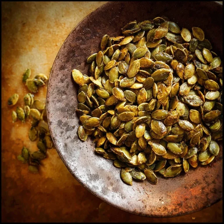 Bowl of roasted pepitas (hulless pumpkin seeds) ready for snacking.
