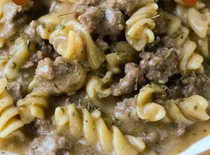Gluten-free and dairy-free beef stroganoff served on a plate with fresh herbs