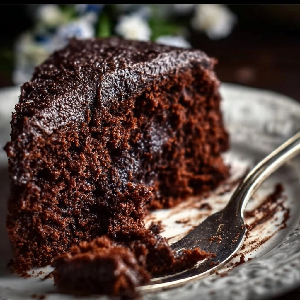 Delicious gluten free chocolate cake topped with chocolate frosting and fresh berries