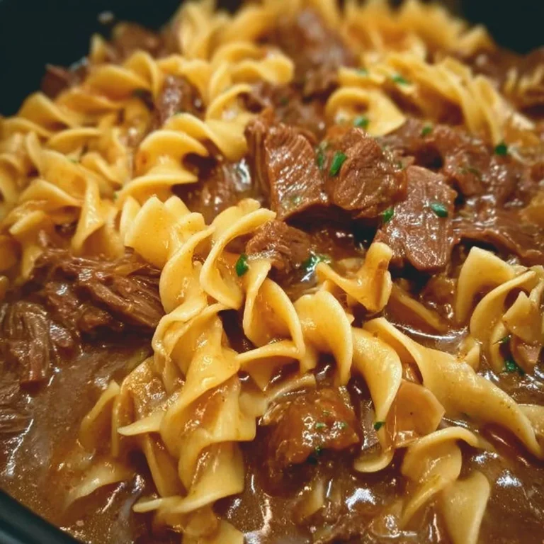 Delicious Crockpot beef and noodles served in a bowl with vegetables